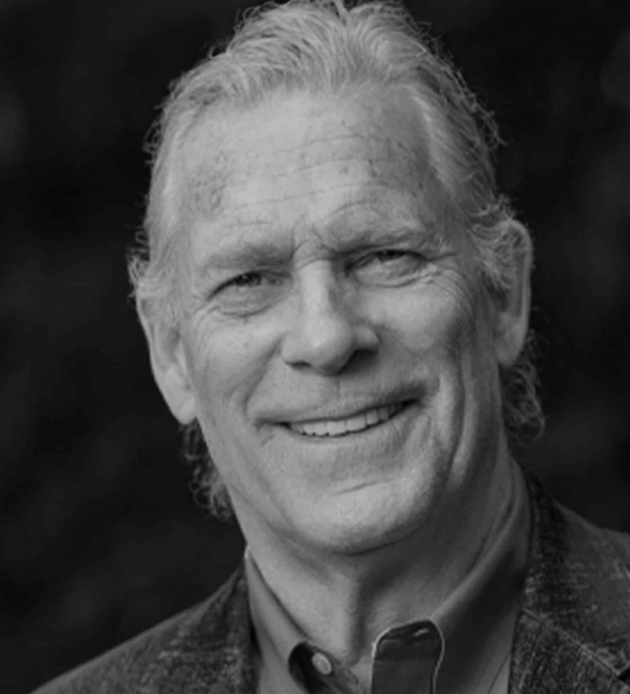Portrait of Trammell S. Crow, founder of EarthX, smiling, in black and white.